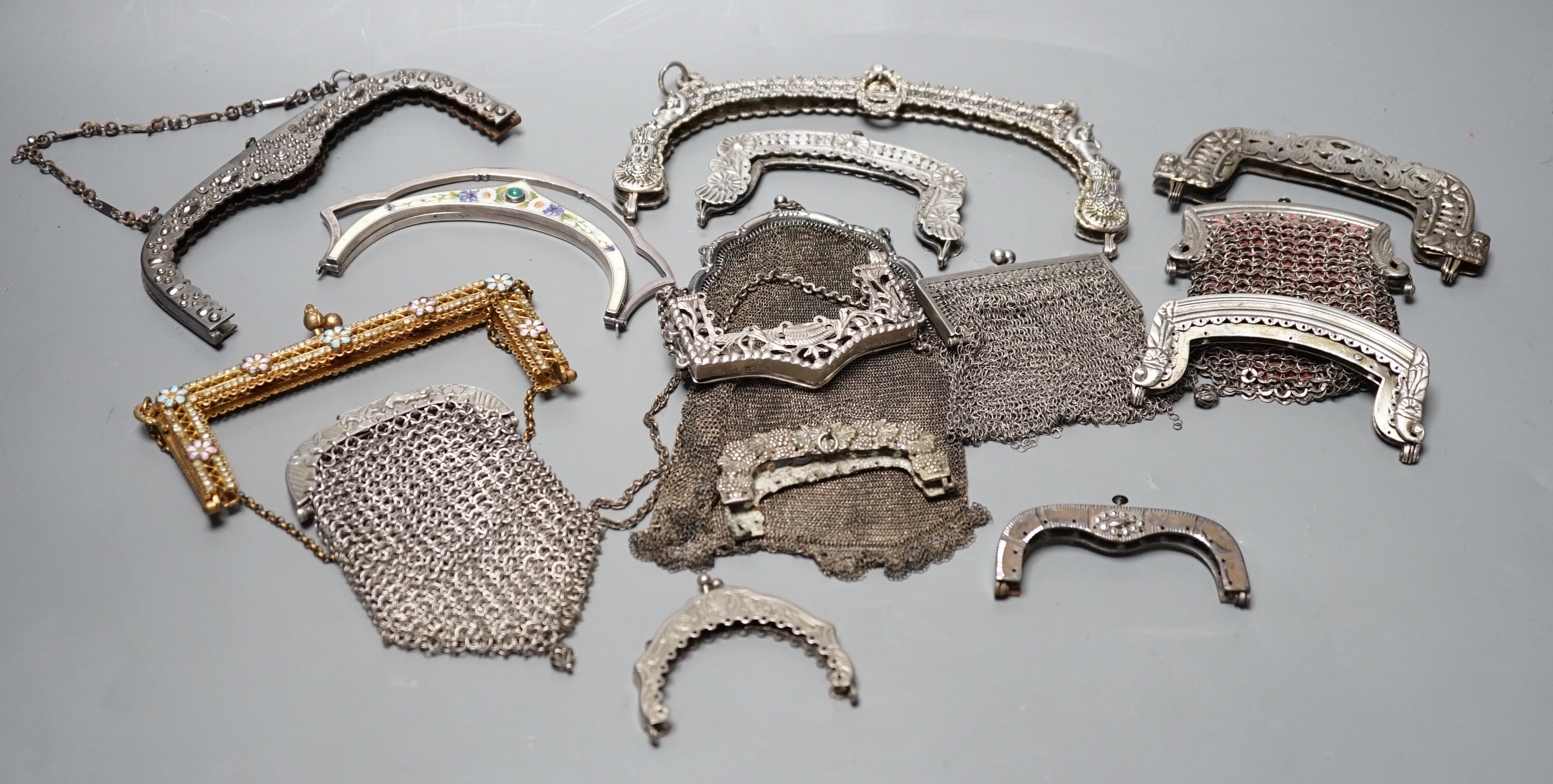 A silver enamel handbag frame, a gilt metal diamanté and enamel frame, eight mixed metal frames, a chain mail bag and three purses, late 19th early 20th century